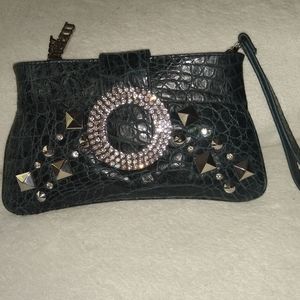 Charm and Luck leather rhinestone wristlet.